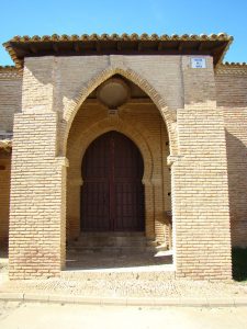 Pórtico de la iglesia Santa María Castillo, con un arco puntiagudo gótico al exterior y un arco de herradura al interior.