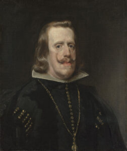 retrato de un hombre con pelo rubio lacio y bigotes largos que curvan hacia arriba; lleva ropa negra con detalles dorados, tiene una cara ovalada y no se ve muy fuerte